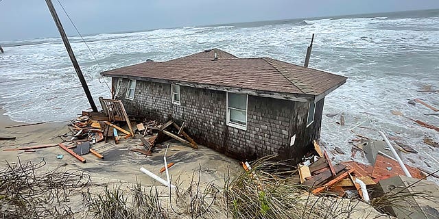 This photo provided by the National Park Service shows a collapsed one-story house in Rodanthe, North Carolina.
