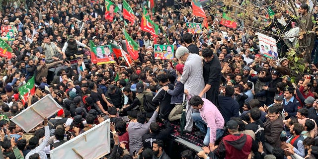 Pakistán libera a un general retirado del ejército acusado de incitar a la violencia contra instituciones nacionales 4 Los simpatizantes se agolpan alrededor de un automóvil en el que viaja el ex primer ministro paquistaní Imran Khan (no aparece en la foto) después de su comparecencia ante el tribunal el 28 de febrero de 2023.