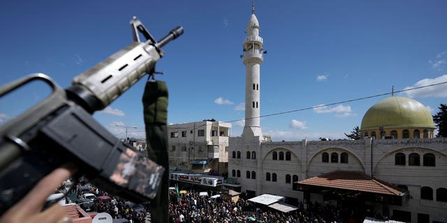 Crowds of protestors were dispersed by armed security forces at the West Bank funeral of a Hamas militant.