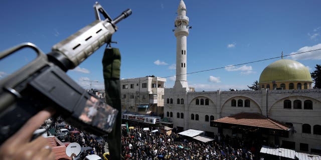 Crowds of protestors were dispersed by armed security forces at the West Bank funeral of a Hamas militant.