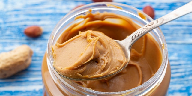 A food allergist/nutritionist recommends mixing two teaspoons of peanut butter with a couple of tablespoons of warm water, breast milk, or formula to create a smooth texture for baby.