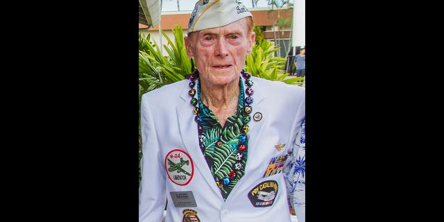 Pearl Harbor survivor Jack Holder poses for photos on Dec. 5, 2016, in Honolulu.