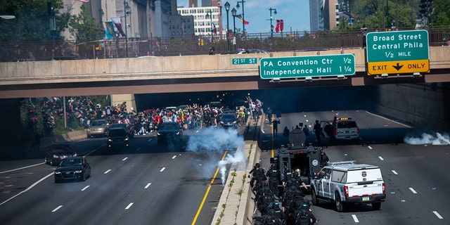 Police officers throw and shoot tear gas into a group of protesters after a march through Center City on June 1, 2020, in Philadelphia.