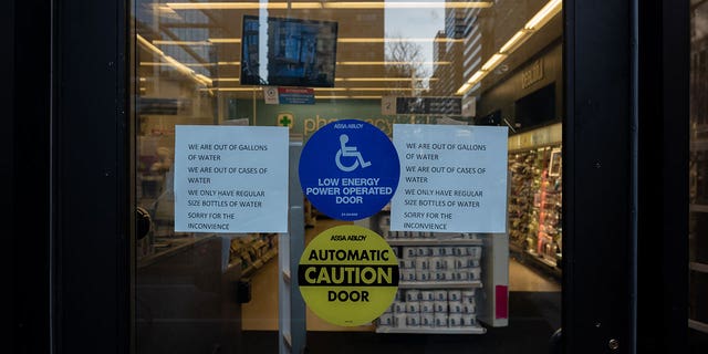 A sign on the front door of a Walgreens in Center City located in Philadelphia March 26, 2023. Water in Philadelphia has been deemed unsafe to drink following a chemical spill in the Delaware River, leading to water bottles being sold out across the city.