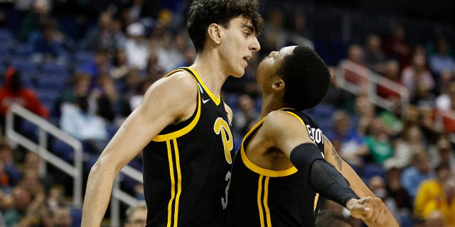 Jorge Diaz Graham, left, and Greg Elliott of the Pittsburgh Panthers celebrate after a play against the Iowa State Cyclones during the second half in the first round of the NCAA Tournament at The Fieldhouse at Greensboro Coliseum March 17, 2023, in Greensboro, N.C.