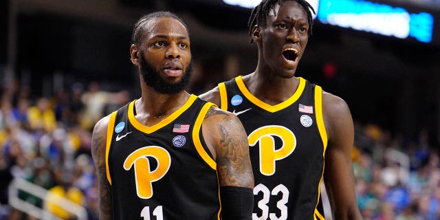 Jamarius Burton (11) and Federiko Federiko (33) of the Pittsburgh Panthers react against the Iowa State Cyclones during the second half in the first round of the NCAA Tournament at The Fieldhouse at Greensboro Coliseum March 17, 2023, in Greensboro, N.C.