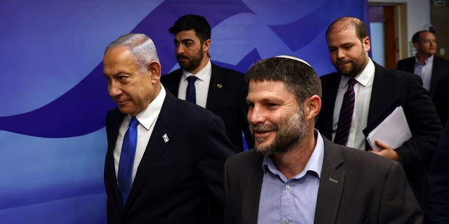 Israeli Prime Minister Benjamin Netanyahu, left, and Finance Minister Bezalel Smotrich, right, arrive to attend a cabinet meeting in Jerusalem on Feb. 23, 2023. Smotrich said there's no such thing as a Palestinian people.
