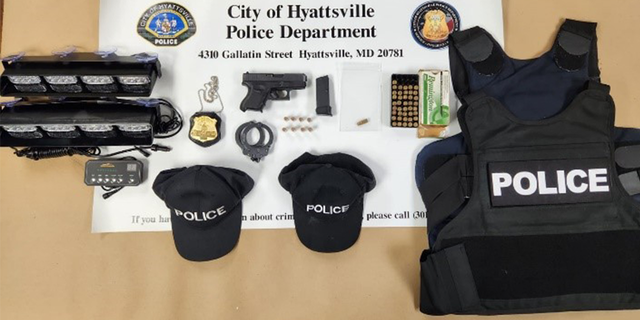 A police-style badge, a loaded handgun, ballistic vest, ammunition, handcuffs and apparel with "police" written on it were found in the suspect's car.