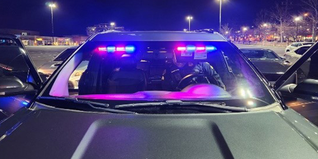 A dark green Ford Explorer was seen in the mall's parking lot with red and blue emergency lights on in the front windshield.
