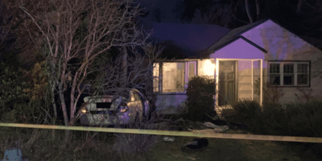 Car seen crashed into Seattle home where a kidnapping victim was able to crawl out of the car's trunk.