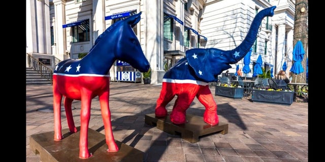 The Democratic donkey and Republican elephant statues symbolize America's two-party political system in front of the Willard Hotel in Washington, DC