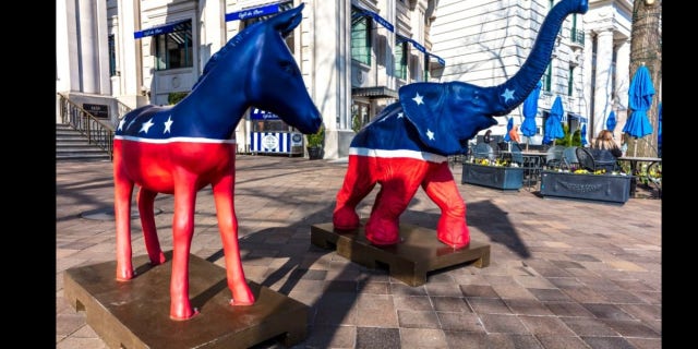 The Democratic donkey and Republican elephant statues symbolize America's two-party political system in front of the Willard Hotel in Washington, DC