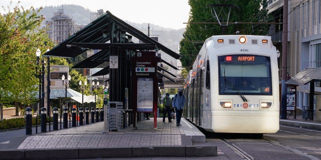 Journalists board a TriMet Metropolitan Area Express (MAX) Light Rail at a stop in Portland, Oregon.  Portland's transit union says there were 170 attacks on the TriMet system in 2022.