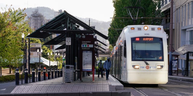 Commuters board a TriMet Metropolitan Area Express (MAX) Light Rail at a stop in Portland, Oregon. Portland's transit union says there were 170 assaults on the TriMet system in 2022.