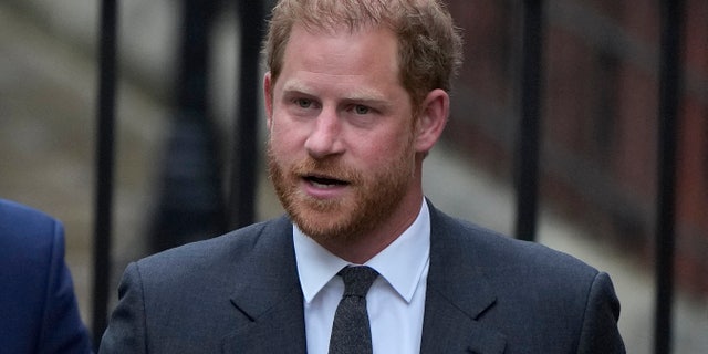 Prince Harry wears a blue suit as he shows up to court.