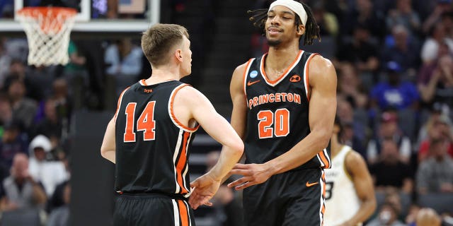 Tosan Evbuomwan (20) and Matt Allocco (14) of the Princeton Tigers react after a basket during the first half against the Missouri Tigers in the second round of the NCAA Tournament at Golden 1 Center March 18, 2023, in Sacramento, Calif.