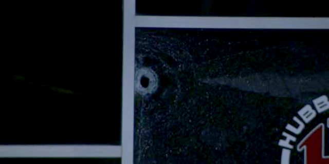 A bullet hole in a window at the hookah lounge police say a man was being kicked out of before the shooting took place.