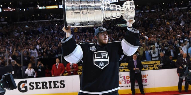 Jonathan Quick #32 of the Los Angeles Kings holds up the Stanley Cup after the Kings defeated the New Jersey Devils 6-1 to win the Stanley Cup series 4-2 in Game Six of the 2012 Stanley Cup Final at Staples Center on June 11, 2012 in Los Angeles, California.