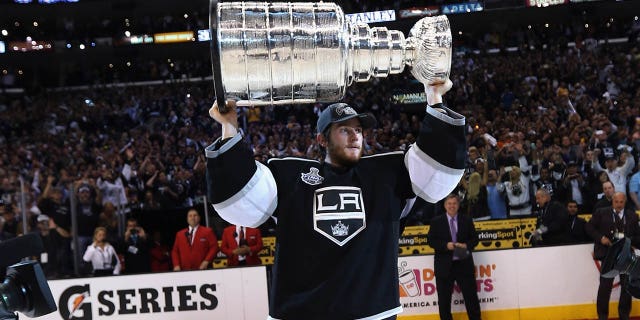 Jonathan Quick #32 of the Los Angeles Kings holds up the Stanley Cup after the Kings defeated the New Jersey Devils 6-1 to win the Stanley Cup series 4-2 in Game Six of the 2012 Stanley Cup Final at Staples Center on June 11, 2012 in Los Angeles, California.