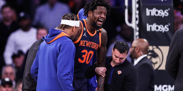 Julius Randle (30) of the New York Knicks walks after being injured during the second quarter of a game against the Miami Heat at Madison Square Garden on March 29, 2023 in New York City. 