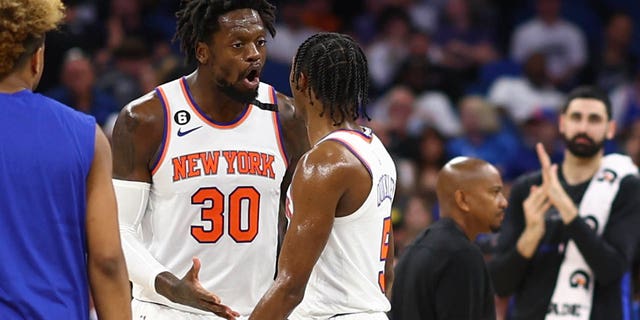 Julius Randle (30) and Immanuel Quickley (5) of the New York Knicks argue in a game against the Orlando Magic at the end the second quarter at Amway Center March 23, 2023, in Orlando, Fla. 