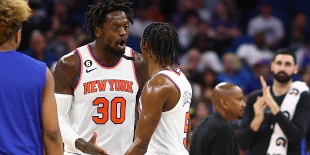 Julius Randle (30) and Immanuel Quickley (5) of the New York Knicks argue in a game against the Orlando Magic at the end the second quarter at Amway Center March 23, 2023, in Orlando, Fla.