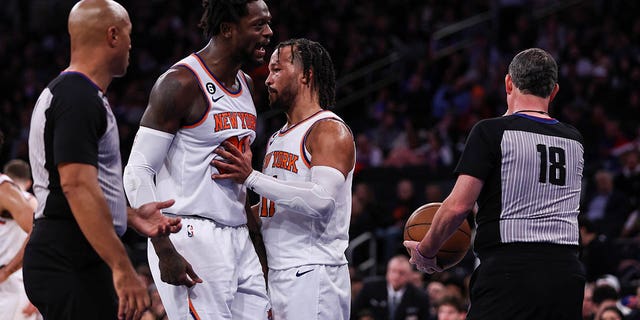 The Knicks' Jalen Brunson (11) restrains Julius Randle (30) as Randle argues with a referee after being ejected during the third quarter of a game against the Sacramento Kings at Madison Square Garden on December 11, 2022. 