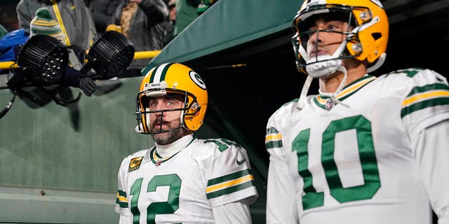 Aaron Rodgers, #12, and Jordan Love, #10, of the Green Bay Packers walk onto the field before the game against the Tennessee Titans at Lambeau Field on November 17, 2022 in Green Bay, Wisconsin. 