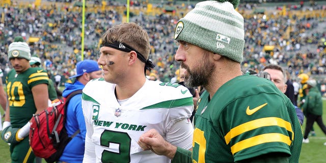 Zach Wilson of the New York Jets speaks with the Packers' Aaron Rodgers after their game at Lambeau Field on Oct. 16, 2022, in Green Bay, Wisconsin.