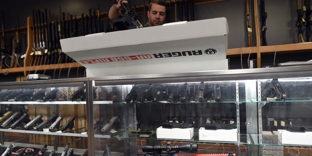 An employee unboxes a Ruger AR-556 rifle at the RTSP Shooting Range in Randolph, New Jersey on Dec. 9, 2015.