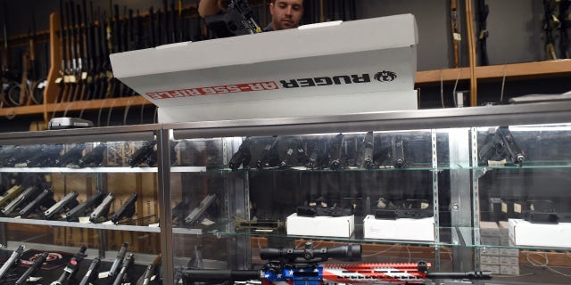 An employee unboxes a Ruger AR-556 rifle at the RTSP Shooting Range in Randolph, New Jersey on Dec. 9, 2015.