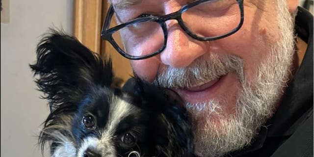 Russell Crowe says his puppy Louis died in his arms while trying to get him to a vet.