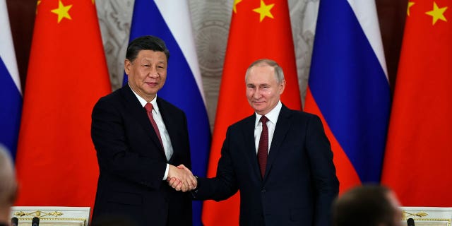 Russian President Vladimir Putin, right, and Chinese President Xi Jinping shake hands following their talks at The Grand Kremlin Palace, in Moscow, Russia, on March 21, 2023. 