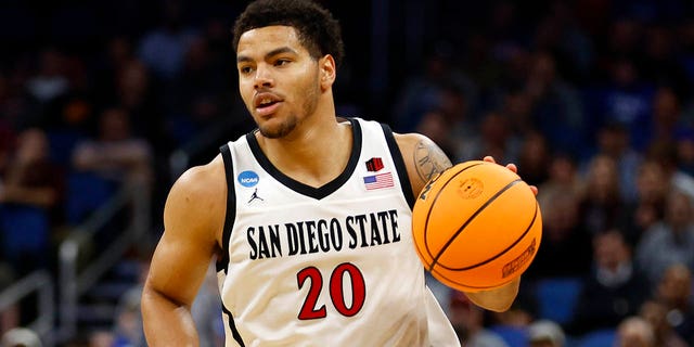 Matt Bradley #20 of the San Diego State Aztecs dribbles the ball against the Charleston Cougars during the second half in the first round of the NCAA Men's Basketball Tournament at Amway Center on March 16, 2023 in Orlando, Florida.