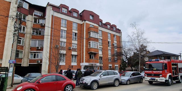 People look at a residential building after a response team extinguished an apartment fire in Novi Pazar, Serbia, March 5, 2023. 