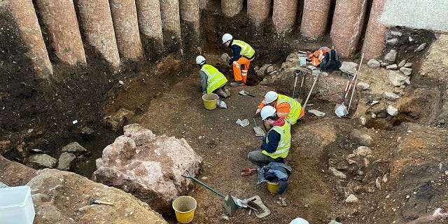 Workers dig in the grounds of Leicester Cathedral, which began in October 2021, in this undated photo. Experts from the University of Leicester said Tuesday that they have uncovered a Roman shrine beneath a former graveyard in central England.