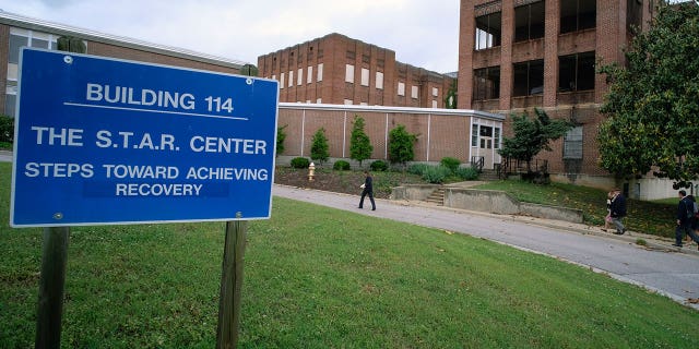 Visitors walk toward a building at Central State Hospital in Virginia on May 17, 2018. Seven deputies were charged with second-degree murder after a Black man died at the Central State Hospital.