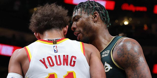 Marcus Smart #36 of the Boston Celtics confronts Trae Young #11 of the Atlanta Hawks before an altercation in which they both fall to the ground during the fourth quarter at State Farm Arena on March 11, 2023 in Atlanta, Georgia.  After a video review, Young was technically fouled and Smart was technically fouled and ejected from the game.