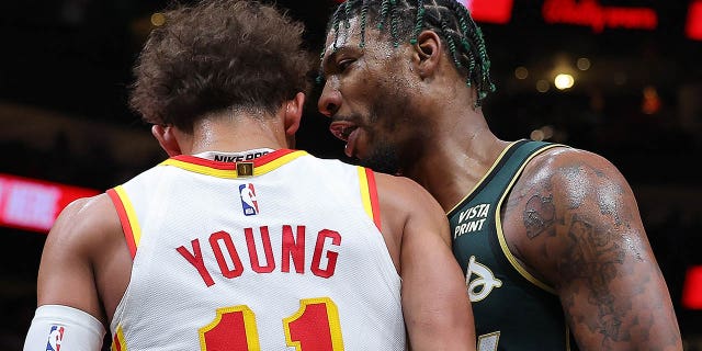 Marcus Smart #36 of the Boston Celtics confronts Trae Young #11 of the Atlanta Hawks before an altercation in which they both fall to the ground during the fourth quarter at State Farm Arena on March 11, 2023 in Atlanta, Georgia.  After a video review, Young was technically fouled and Smart was technically fouled and ejected from the game.