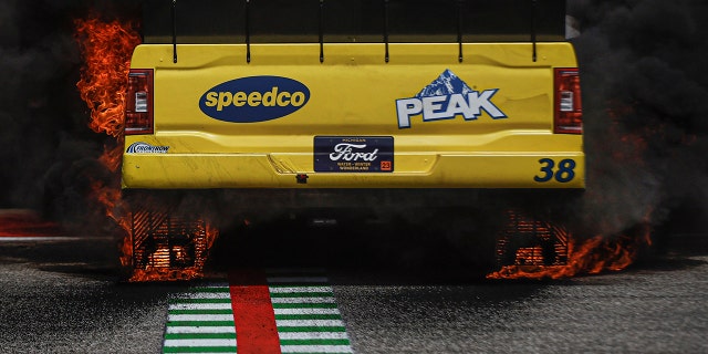 Rubber dust is shaved off the tires during a burnout.