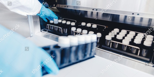 A medical professional places samples in a sperm bank for storage and analysis.