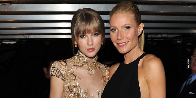 Taylor Swift and Gwyneth Paltrow smile backstage at the Grammy Awards in 2012.