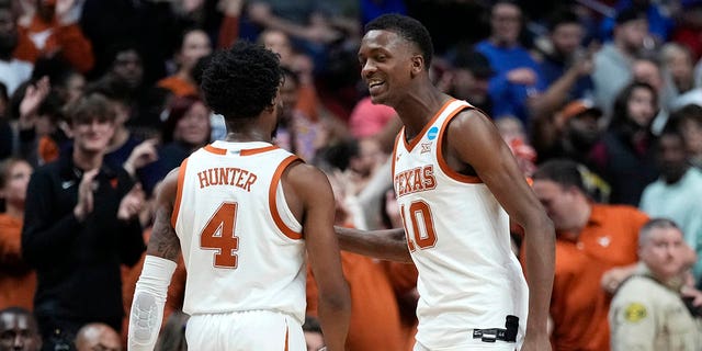 Texas guard Tyrese Hunter (4) celebrates with teammate guard Sir'Jabari Rice (10) in the first half of a second-round college basketball game against Penn State in the NCAA Tournament, Saturday, March 18, 2023, in Des Moines, Iowa.