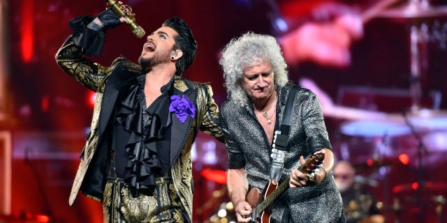 Adam Lambert, left, and Brian May of Queen + Adam Lambert perform in Chicago on Aug. 9, 2019.