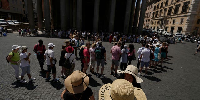 Tourists queue to visit Rome's Pantheon on June 17, 2022.