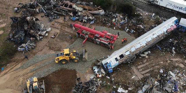 The wreckage of the trains lie next to the rail lines in Tempe, Greece, on March 3, 2023. 