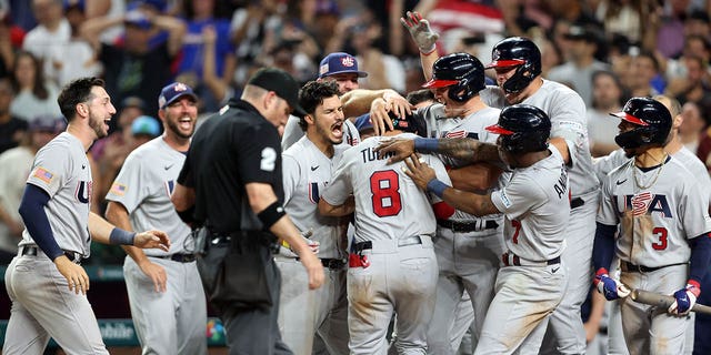 Members of Team USA celebrate after Trea Turner #8 fell during the 2023 World Baseball Classic quarterfinal game between Team USA and Team Venezuela on Saturday, May 18, 2023. 