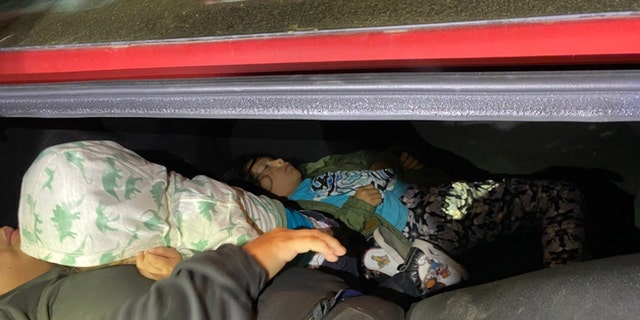 A mother and two children, ages 7 and 2, were found in the trunk of a car that had been smuggled into the United States on March 14, 2023. 