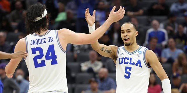 Amari Bailey #5 of the UCLA Bruins and Jaime Jaquez Jr. #24 of the UCLA Bruins embrace during the second half of a game against the North Carolina-Asheville Bulldogs in the first round of the NCAA Men's Basketball Tournament at Golden 1 Center on March 16, 2023 in Sacramento, California. 