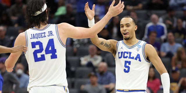 Amari Bailey #5 of the UCLA Bruins and Jaime Jaquez Jr. #24 of the UCLA Bruins embrace during the second half of a game against the North Carolina-Asheville Bulldogs in the first round of the NCAA Men's Basketball Tournament at Golden 1 Center on March 16, 2023 in Sacramento, California.